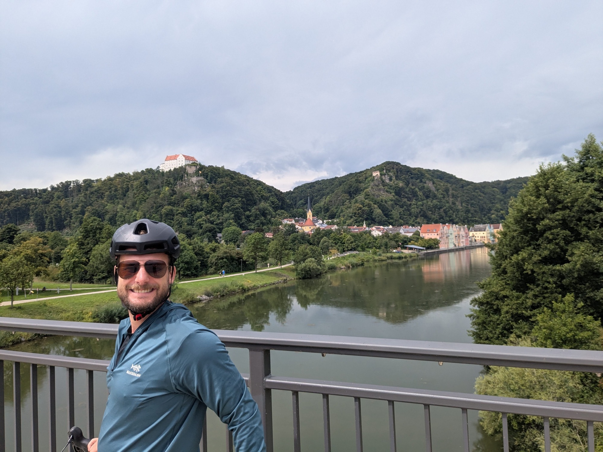 Tyler overlooking a city and hillside on our ride