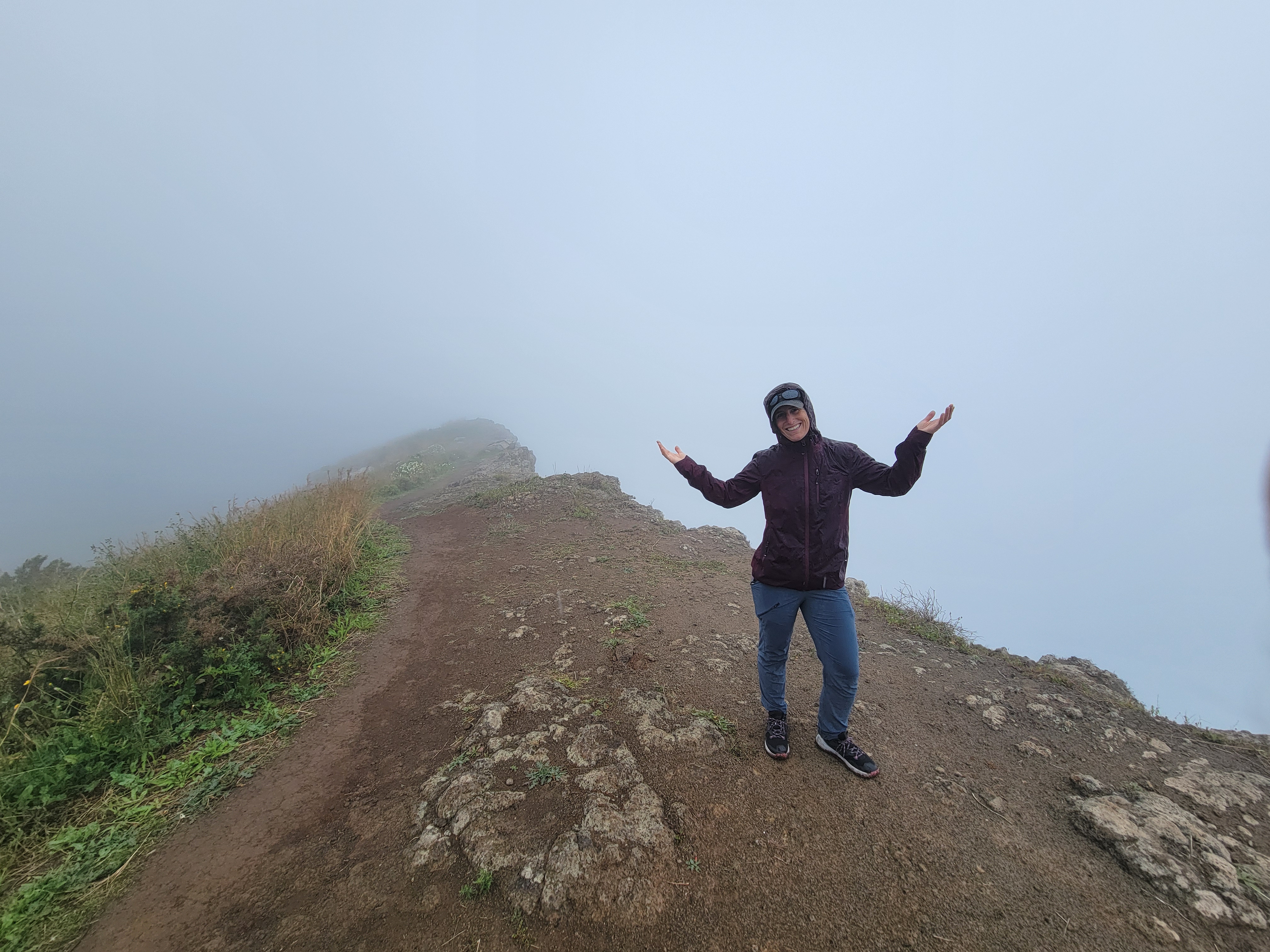 Not all hikes are great, Randi at the top of a peak looking at clouds