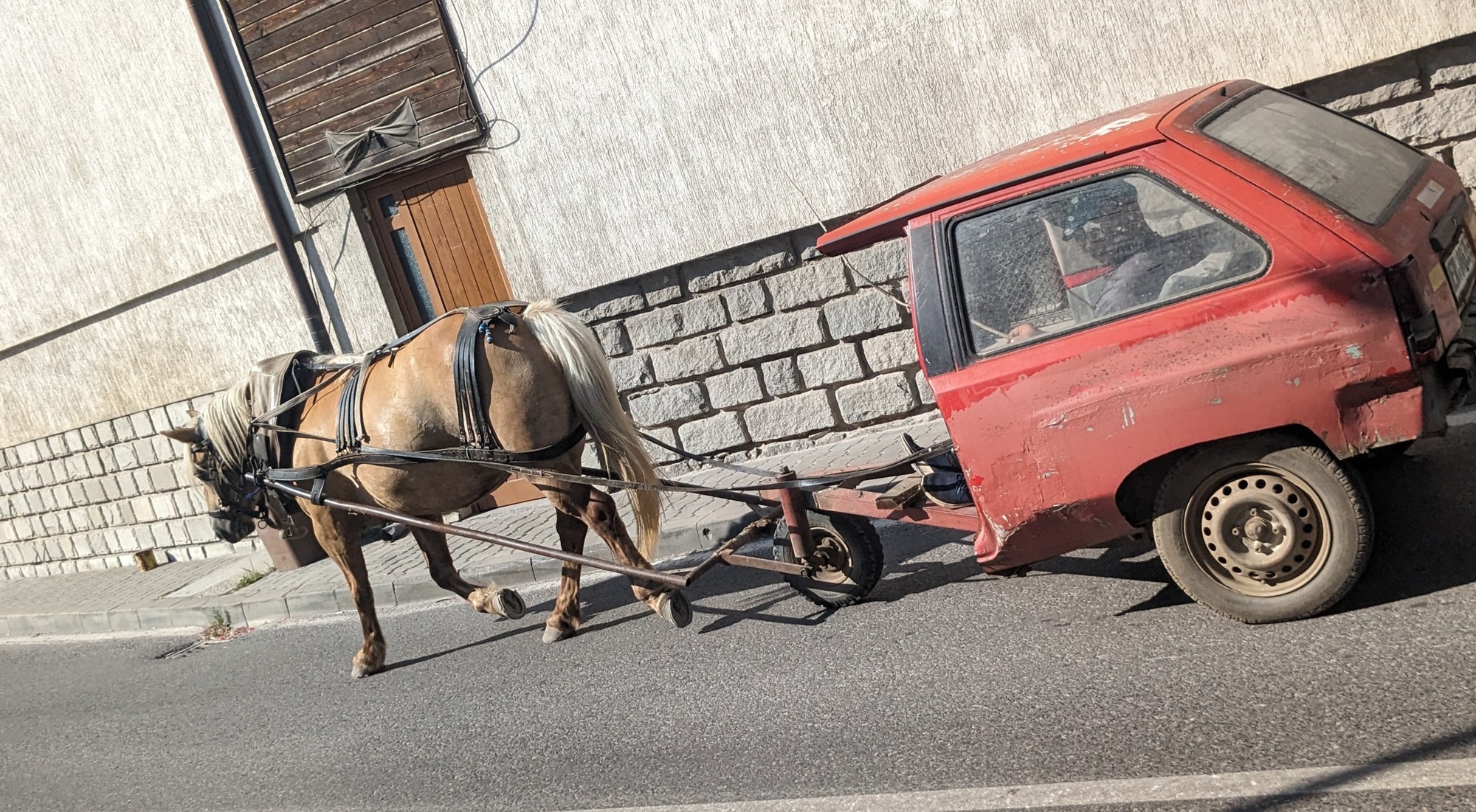 Car being pulled by horse