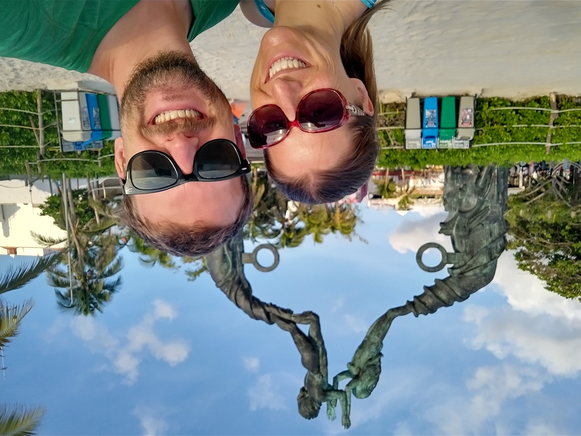 Us under a famous statue in Playa Del Carmen