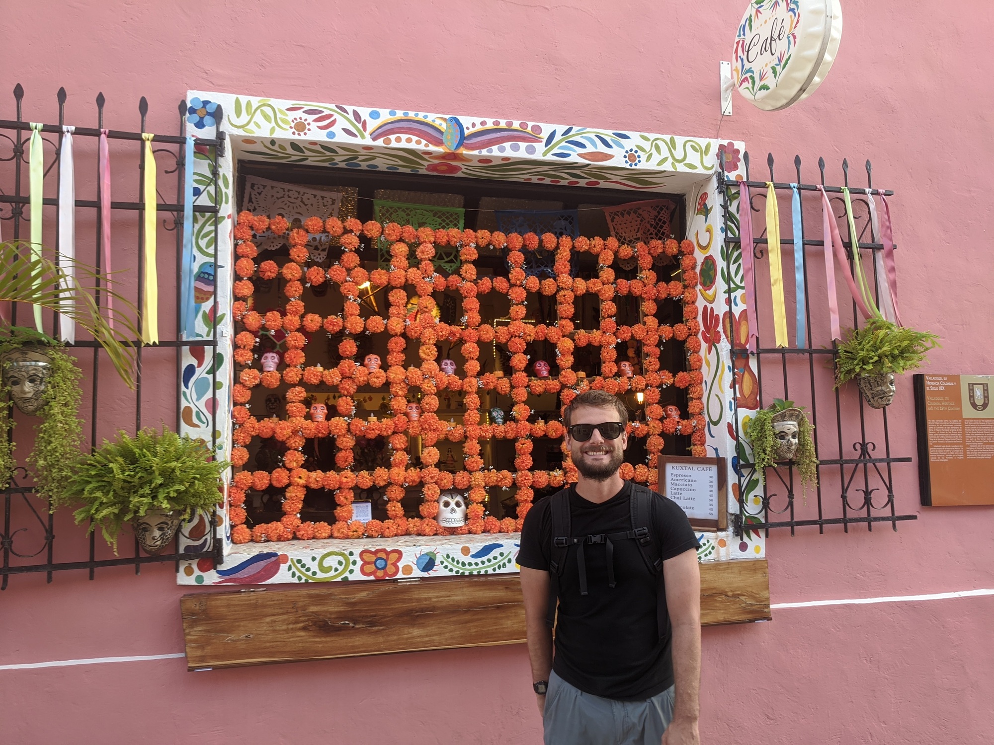 Tyler standing by a coffee shop in town.