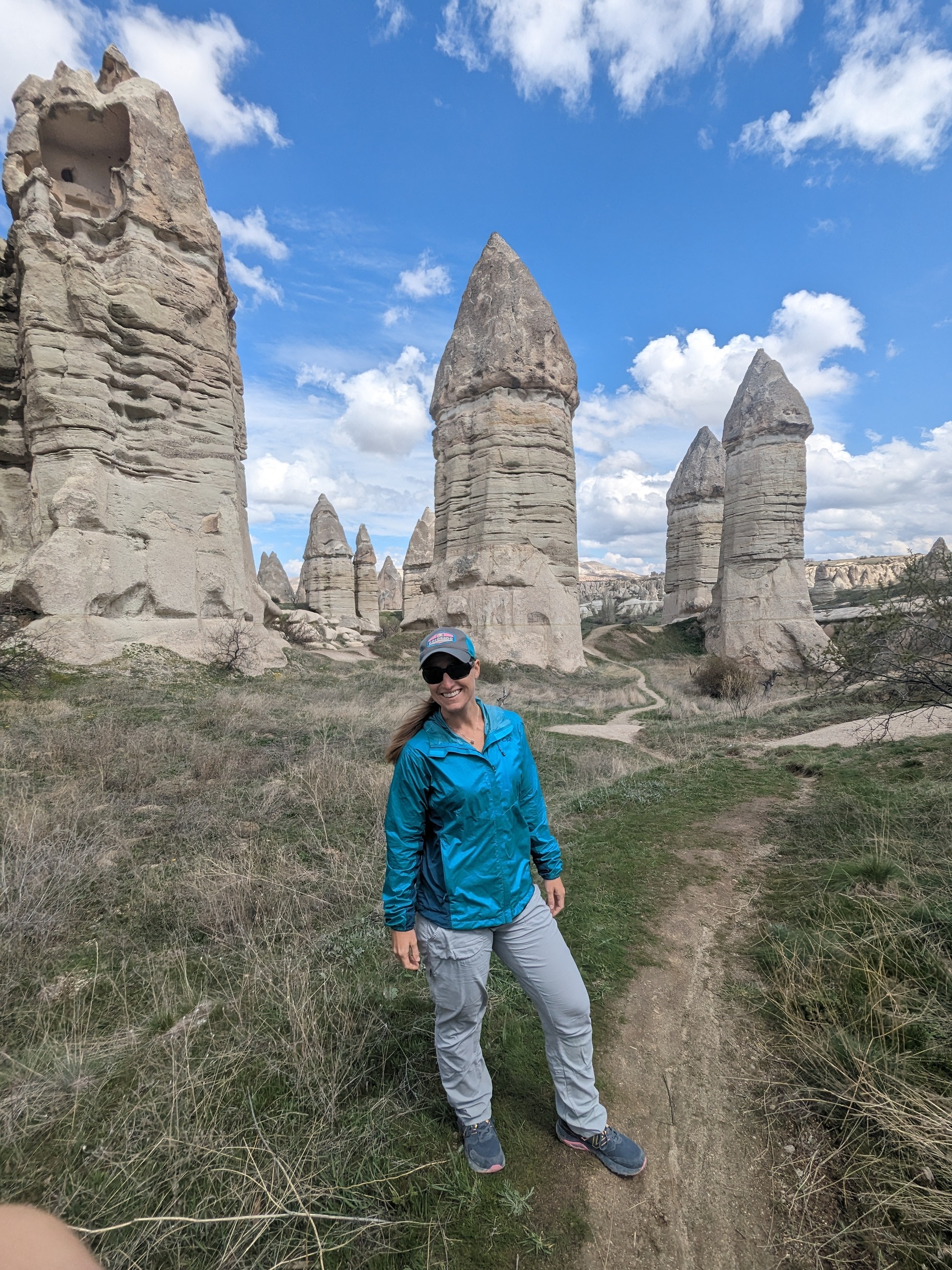 Randi standing by stone pillars known in the Cappadocia